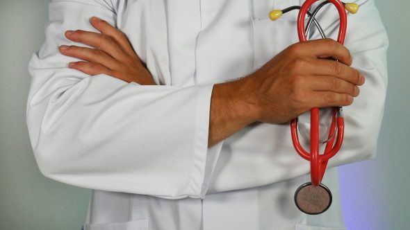 Picture of a doctor with his arms crossed.