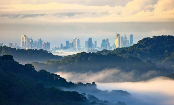 Panama City skyline at dusk with high-rise residential towers along the waterfront